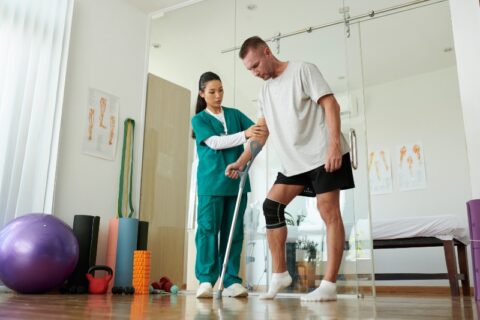 Patient using crutches in physiotherapy clinic in Clayton Heights Surrey Langley