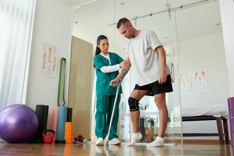 Patient using crutches in physiotherapy clinic in Clayton Heights Surrey Langley